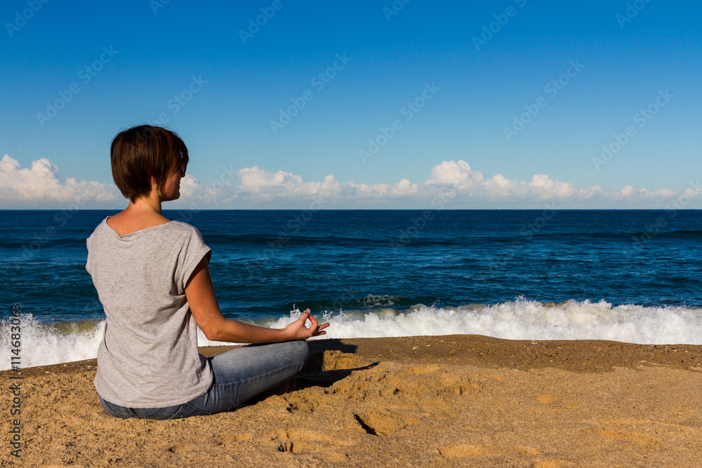 Young Woman relax on a Beach with waves in Background