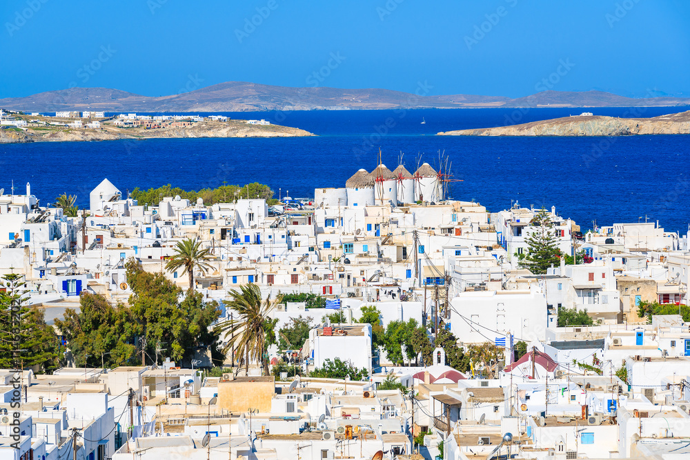 A view of Mykonos town with famous windmills and blue sea, Cyclades islands, Greece