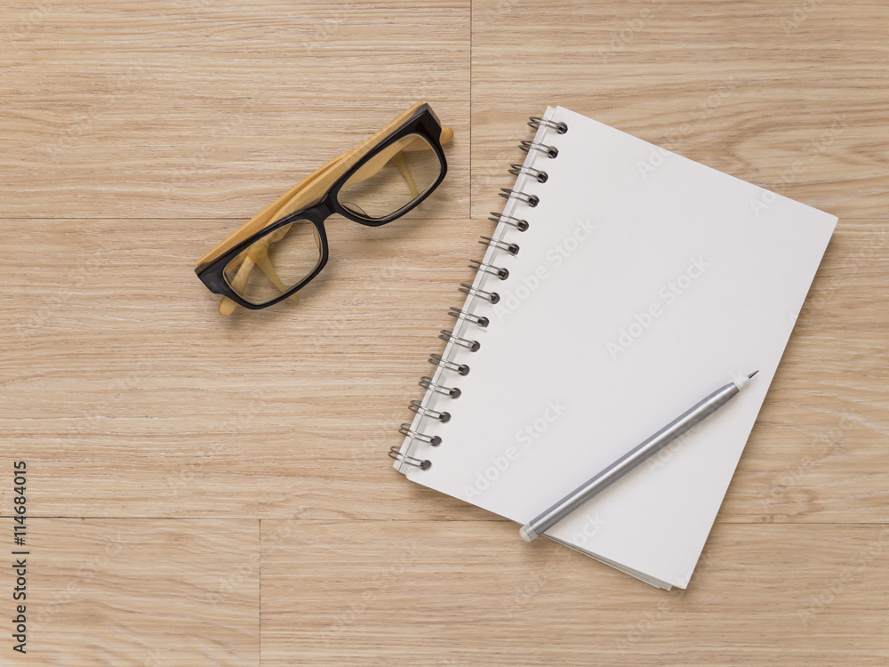 notebook eye glasses and pencil on wood floor notebook eye glasses and pencil on wood floor
