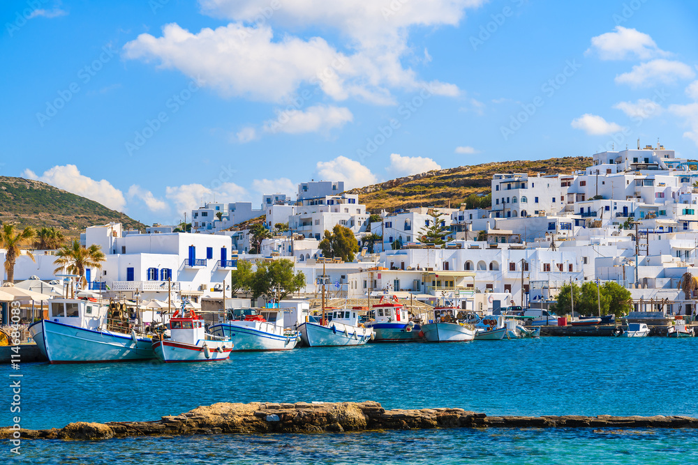 A view of Naoussa port with white houses and traditional fishing boats, Paros island, Greece