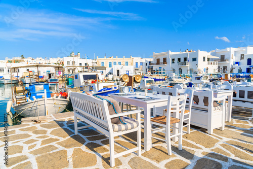 Taverna tables in traditional fishing port, Naoussa village, Paros island, Greece