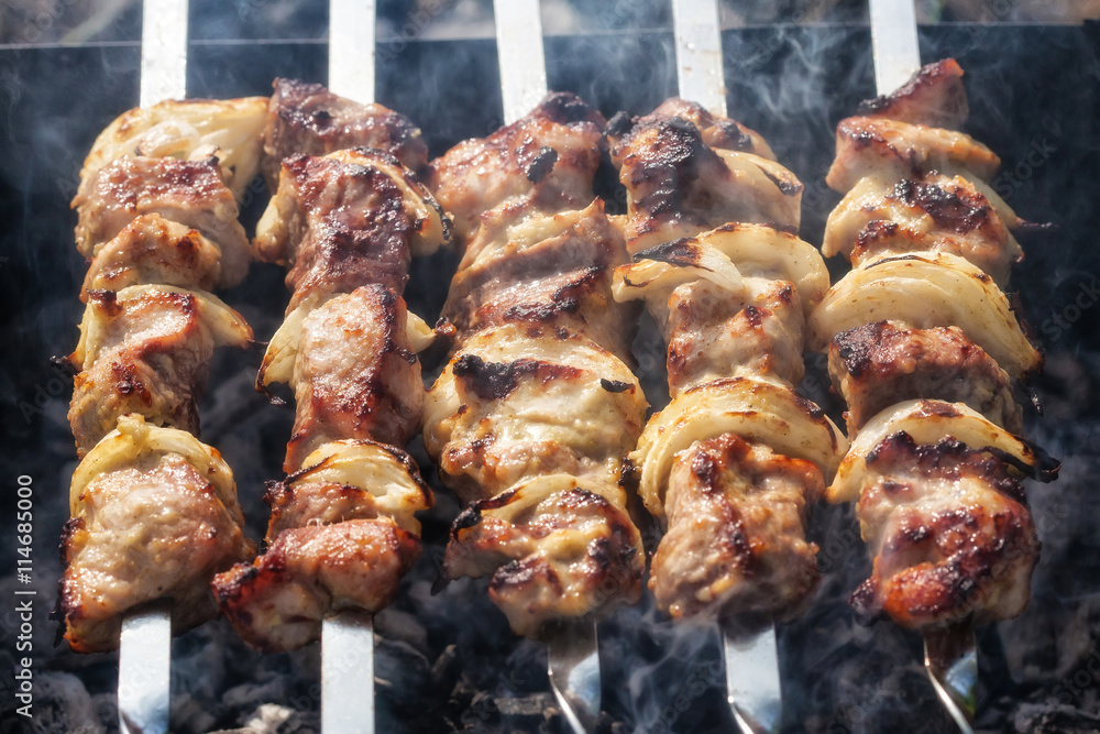 Barbecue skewers with grilled pork meat on the brazier