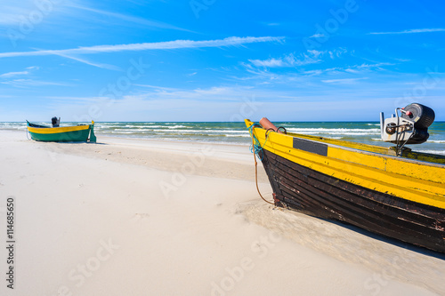 Colorful fishing boats on sandy Baltic Sea beach in Debki village, Poland