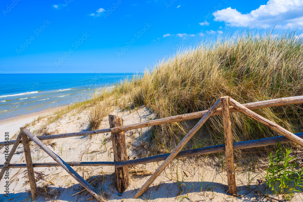 Entrance to idyllic sandy beach in Bialogora coastal village, Baltic Sea, Poland