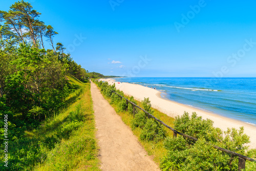 Fototapeta Naklejka Na Ścianę i Meble -  Coastal path along beautiful sandy beach in Jastrzebia Gora village, Baltic Sea, Poland