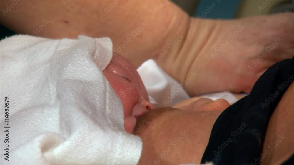 Close-up of newborn nursing at his mother's breast