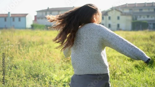 Spinning around in meadow