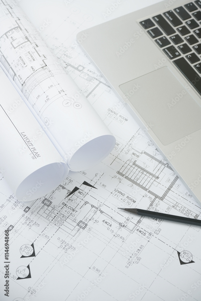 black pencil and computer laptop on architectural drawing paper for construction black pencil and computer laptop on architectural drawing paper for construction