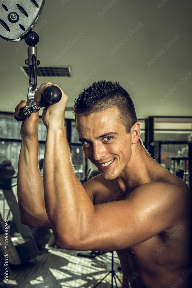 Man doing triceps pull downs Man doing triceps pull downs