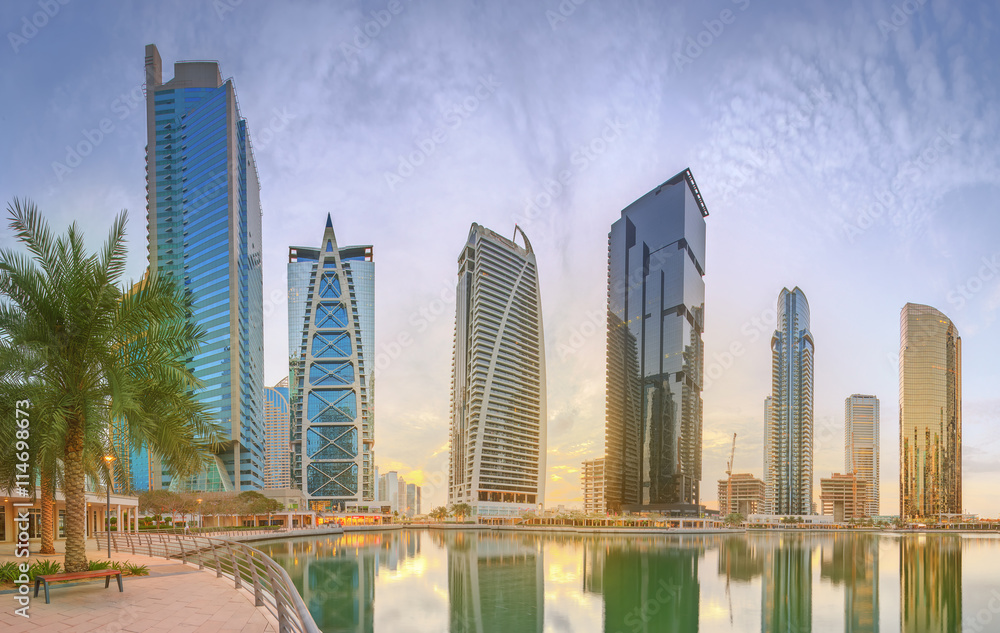 Fototapeta premium Panoramic view of Business bay and Lake Tower, reflection in a river, UAE