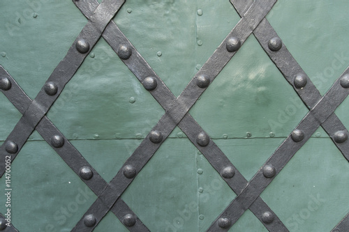 Metal stripes on a green door 