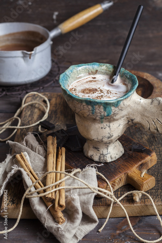Hot cocoa with cream and cinnamon photo