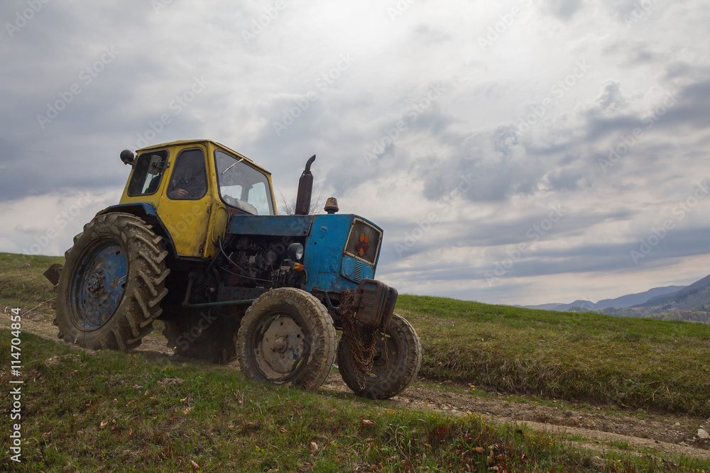 Old tractor riding in the highlands Old tractor riding in the highlands