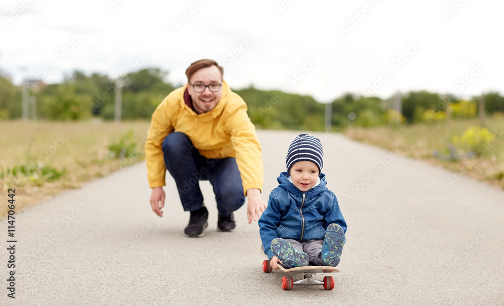 happy father and little son riding on skateboard happy father and little son riding on skateboard