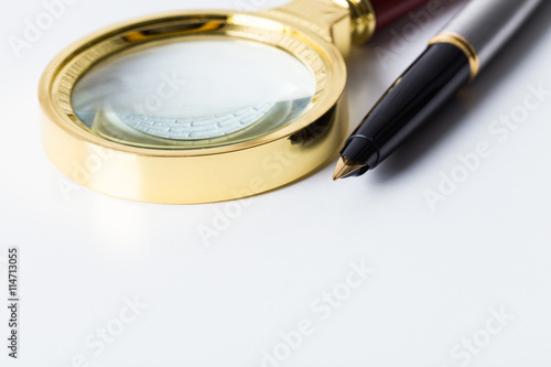 Pen and magnifying glass