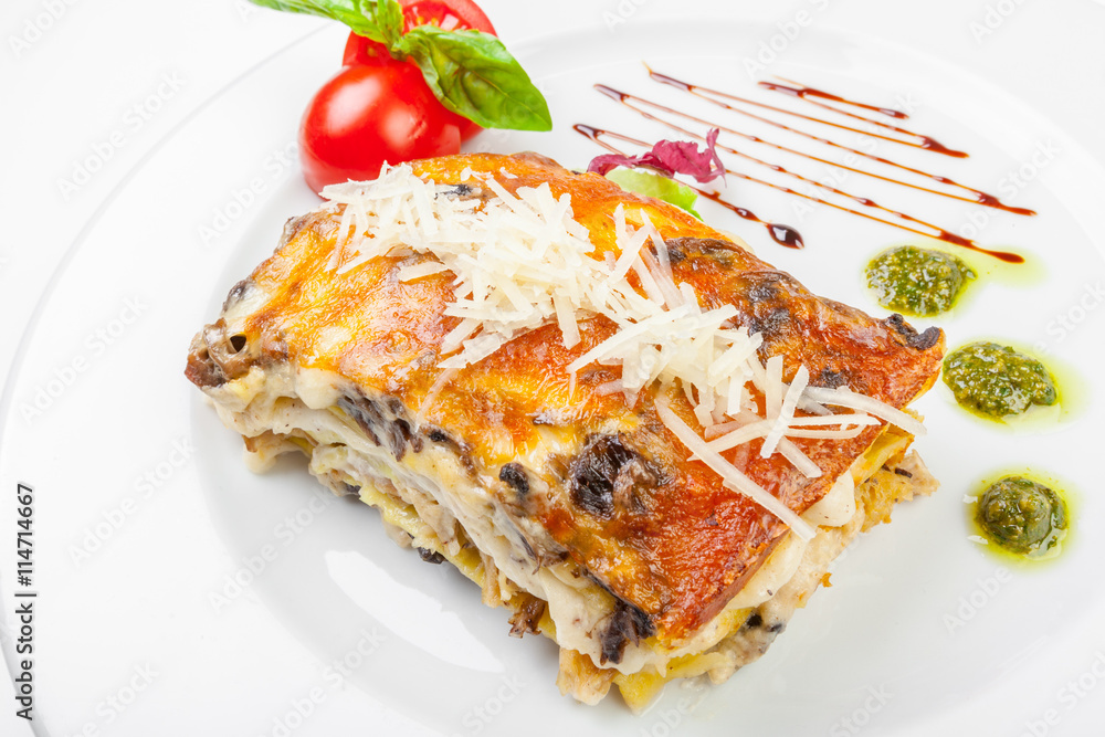 Portion of tasty lasagna, isolated on white Portion of tasty lasagna, isolated on white