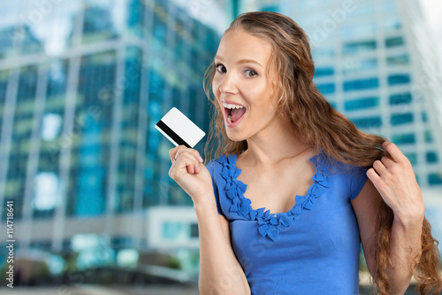 beautiful young smiling woman holding credit card