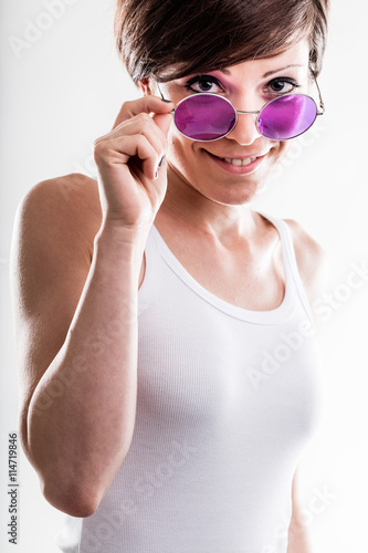 Trendy young woman wearing purple sunglasses
