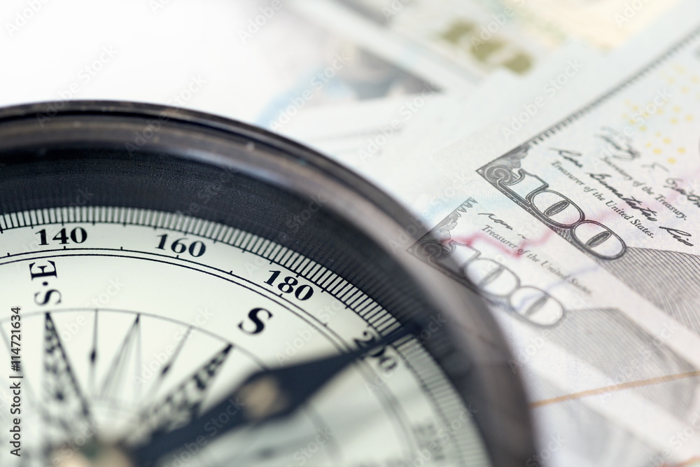 A collage with compass and US dollar bills. A collage with compass and US dollar bills.
