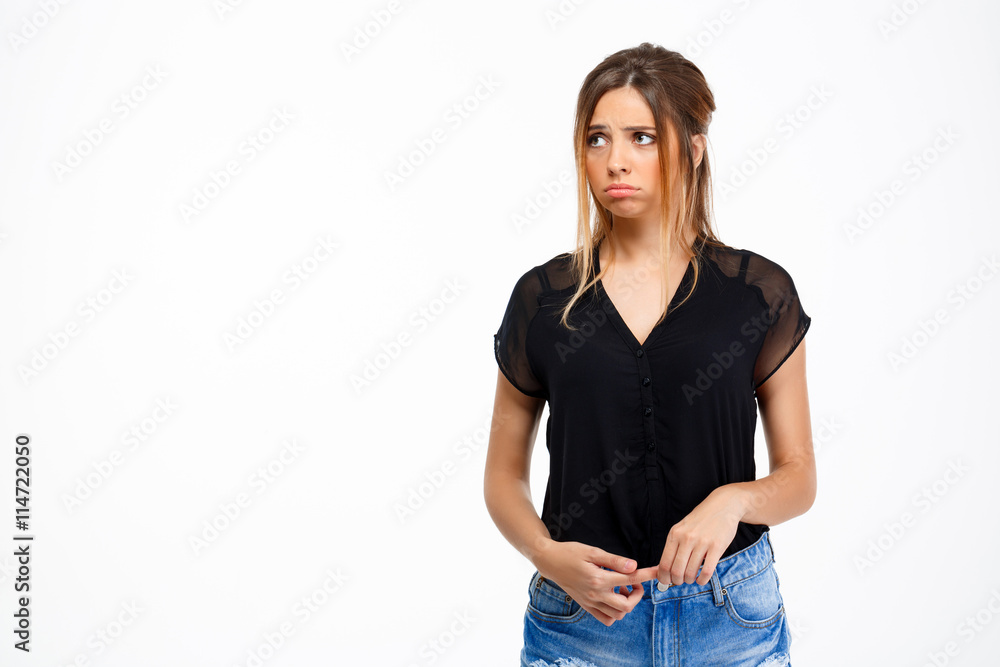 Portrait of young sad beautiful girl over white background. Copy space. Portrait of young sad beautiful girl over white background. Copy space.