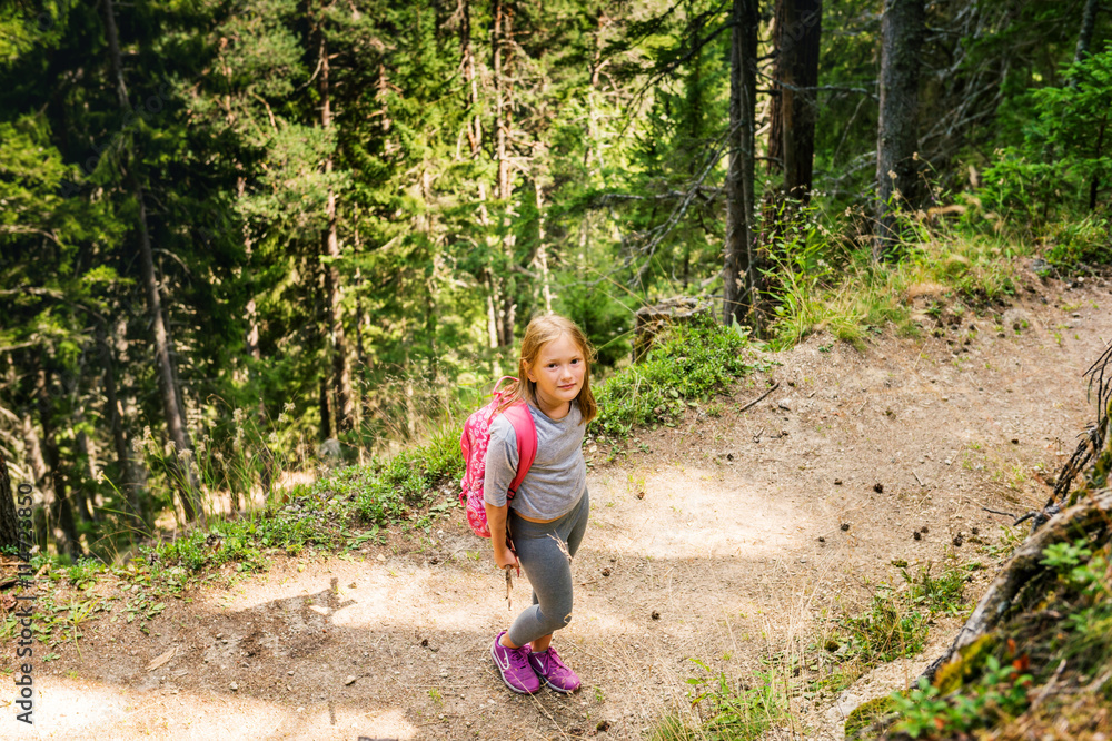 Little hiker girl in forest. Photo from Champex-Lac, Valais, swiss Alps, top view Little hiker girl in forest. Photo from Champex-Lac, Valais, swiss Alps, top view