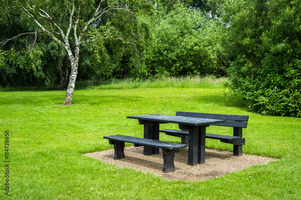 Picnic table beside a forest in summer in Milton Keynes, England Picnic table beside a forest in summer in Milton Keynes, England