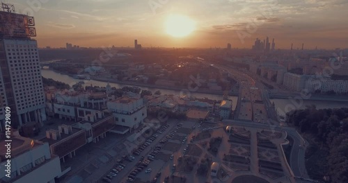 Aerial view of the Luzhnetsky metro bridge, passenger boat floating along the Moscow River, heavy traffic and building of Russian Academy of Sciences during amazing sunset  in Moscow, Russia.   photo