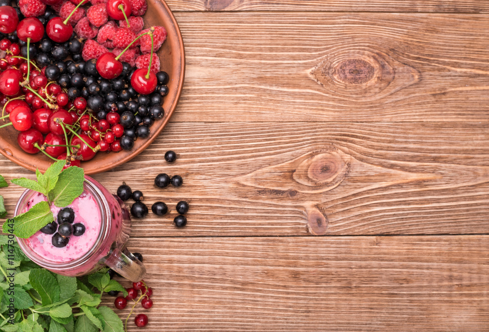 Smoothies with fresh berries currants in glass jar on a wooden background. Smoothies with fresh berries currants in glass jar on a wooden background.