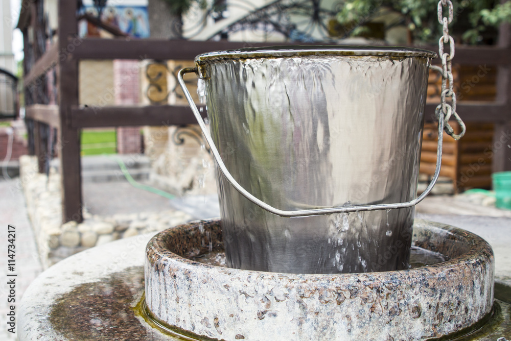 water is coming out of a metal bucket
water is coming out of a metal bucket