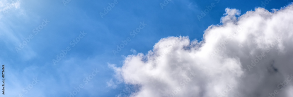 Obraz premium White fluffy clouds over blue sky. Nature background