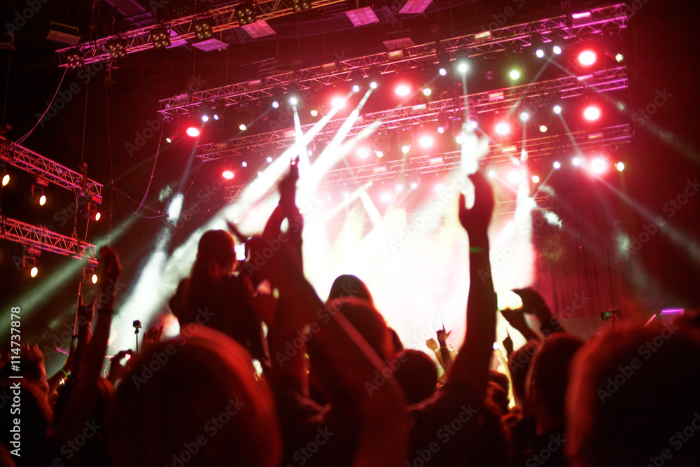 abstract soft background, the fans in the concert hall, hands in the air