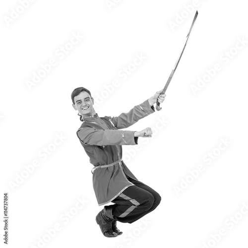 colorless portrait of Russian cossack dance. Young dancer posing with sword