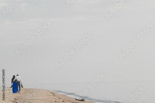 Image of beautiful couple posing on the sea