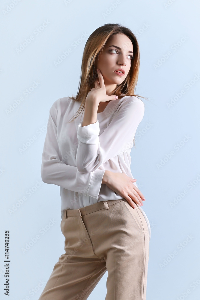Woman in white long sleeve shirt and beige pants sitting on brown wooden  bench during daytime photo – Free Clothing Image on Unsplash