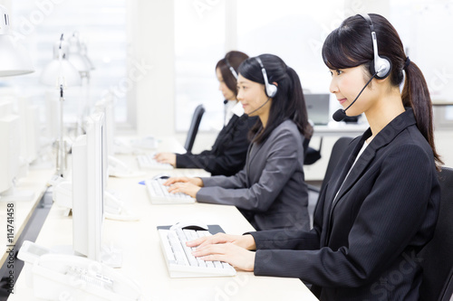 Plakat asian operator working in office