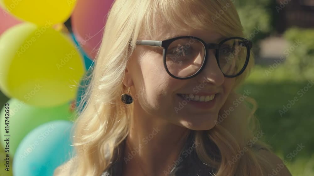 Girl with balloons in nature making facial expressions and shows tongue. RAW video record. Girl with balloons in nature making facial expressions and shows tongue. RAW video record.