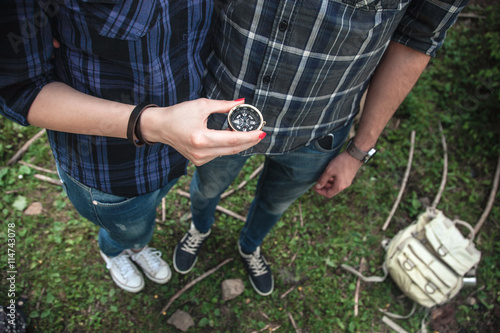 A couple of travelers looking at the compass