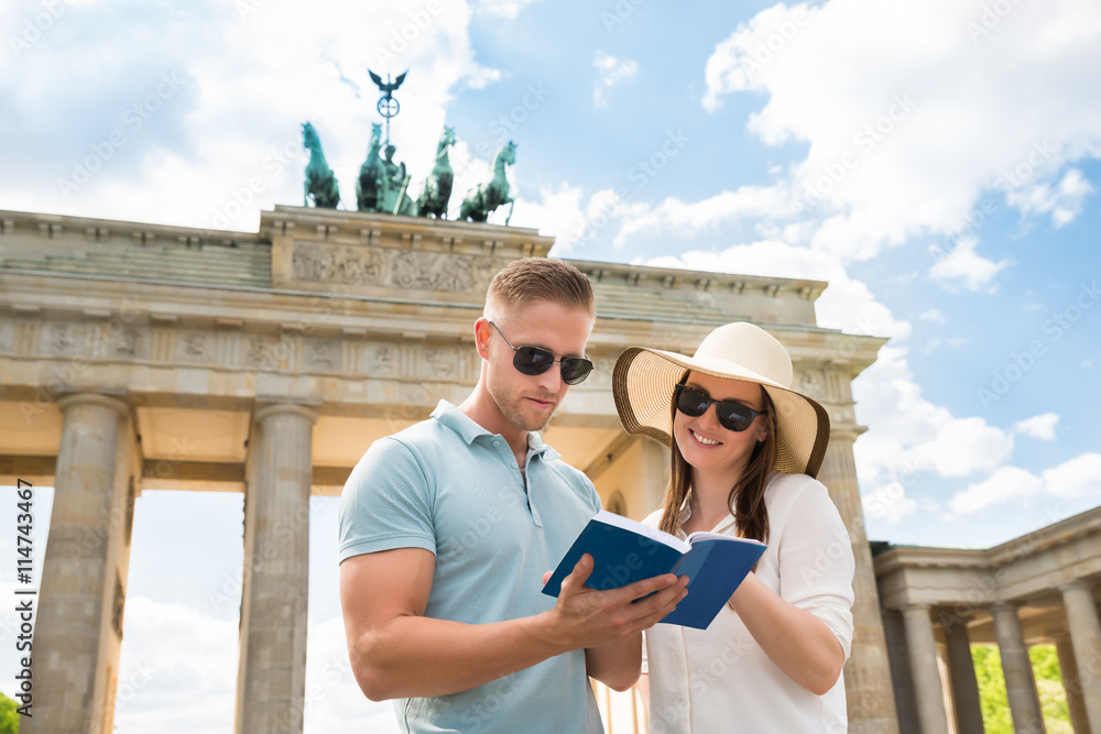 Young Couple Reading Tourist Guide