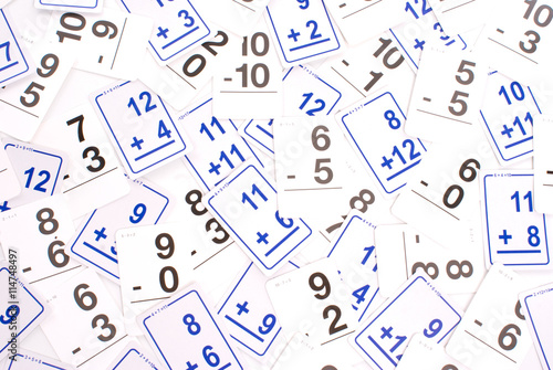 Slika na platnu Education: Addition math cards (blue) and subtraction math cards (black) randomly spread out on table