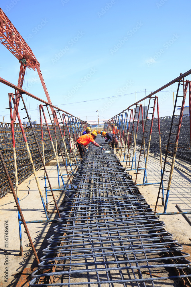 In the construction site, the welding workers at work In the construction site, the welding workers at work