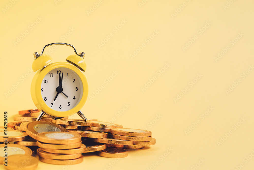 alarm clock and coins alarm clock and coins