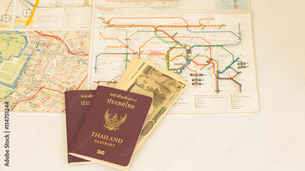 Passport and Japanese banknote on blur subway map