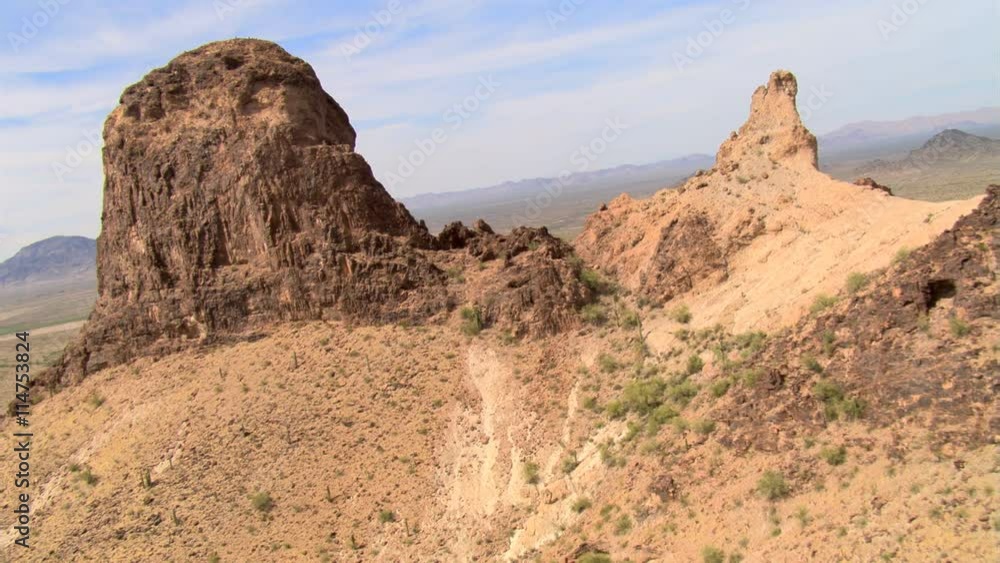 Flight over cliff top rock formations to reveal a desert valley. Shot in 2007. Flight over cliff top rock formations to reveal a desert valley. Shot in 2007.