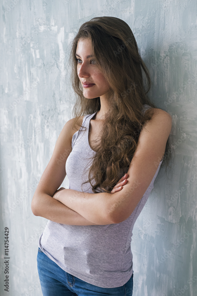 Portrait of beautiful calm brunette with wavy hair looking away Portrait of beautiful calm brunette with wavy hair looking away