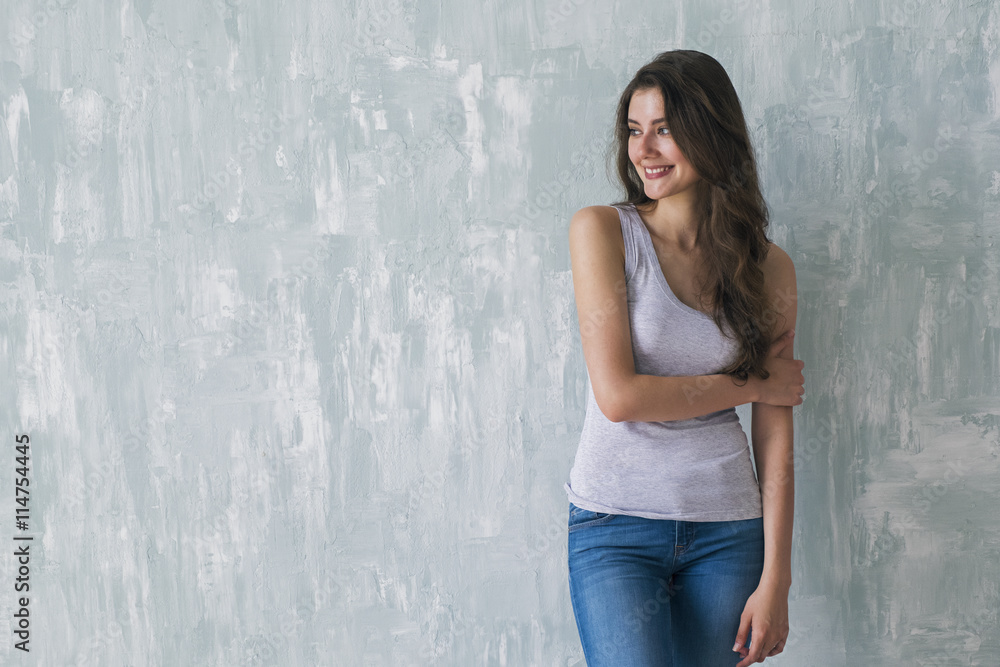 Beautiful smiling brunette embracing herself with one arm Beautiful smiling brunette embracing herself with one arm