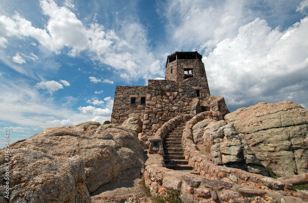 Harney Peak Fire Lookout watchtower with cumulus clouds overhead in Custer State Park in the Black Hills of South Dakota USA