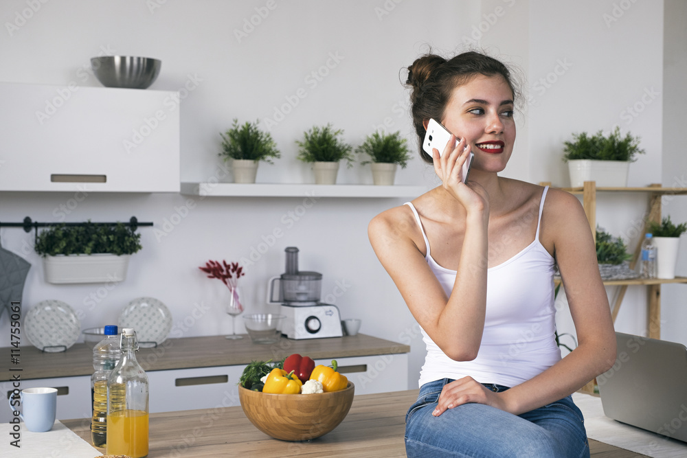 Portrait of young brunette woman looking away while talking on cell Portrait of young brunette woman looking away while talking on cell