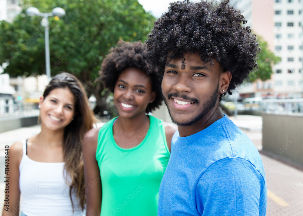 African american young adult with two beautiful girls in the city African american young adult with two beautiful girls in the city