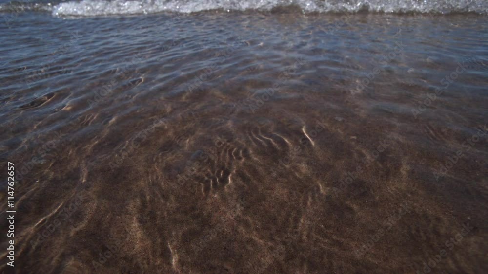 Ultra-slow motion incoming tide on sandy beach Ultra-slow motion incoming tide on sandy beach