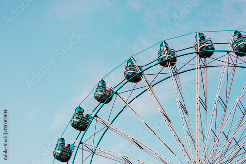 abstract background of ferris wheel at the fun park with blue sky on background with vintage tone  photo